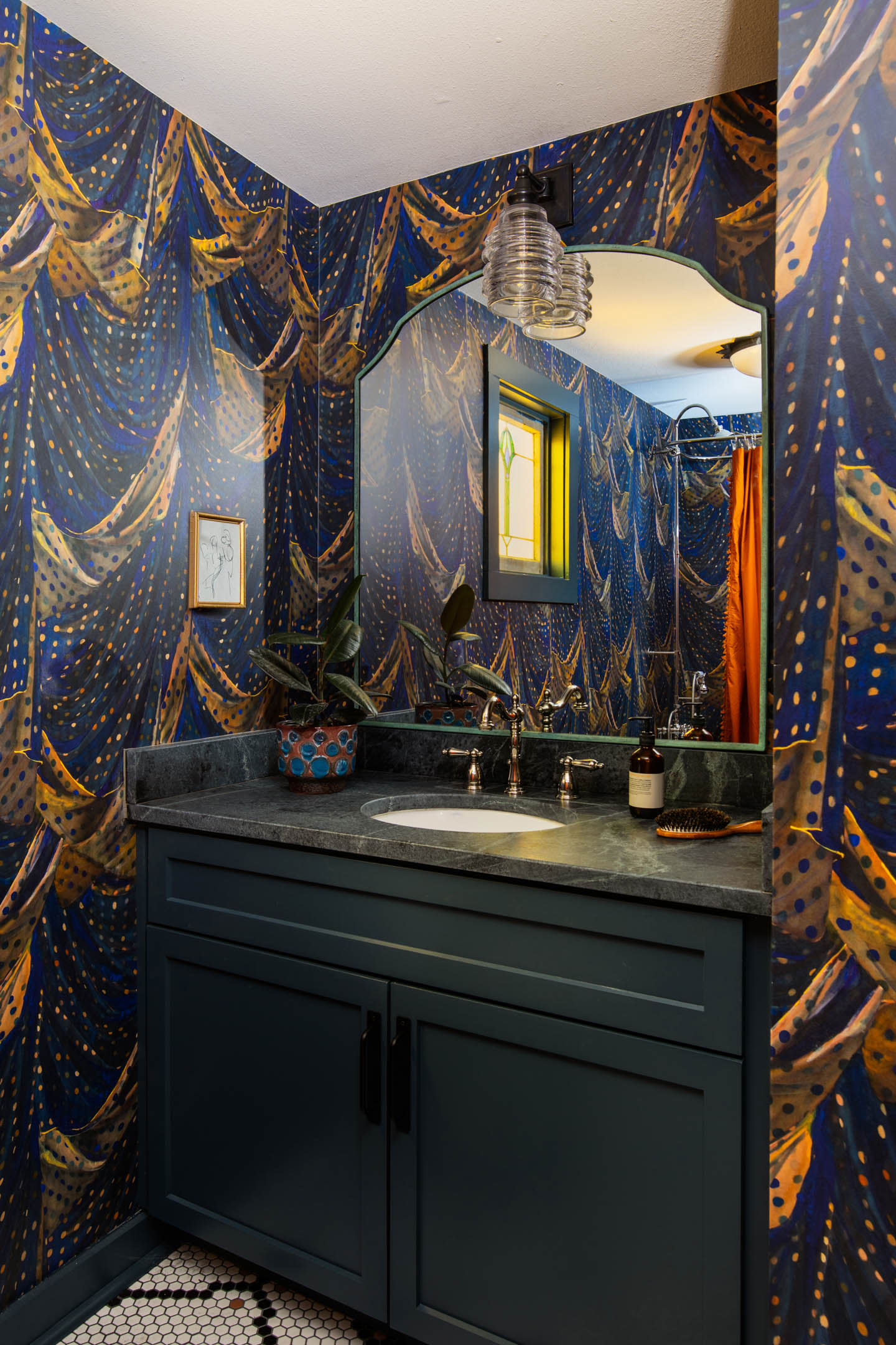 blue and yellow graphic wallpaper in a half bath