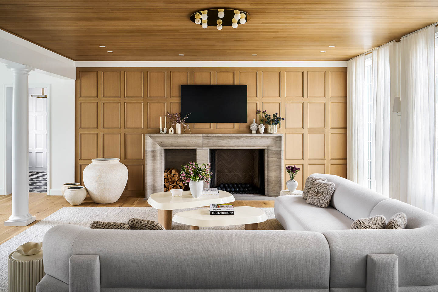 family room with a white oak accent wall matching the ceiling