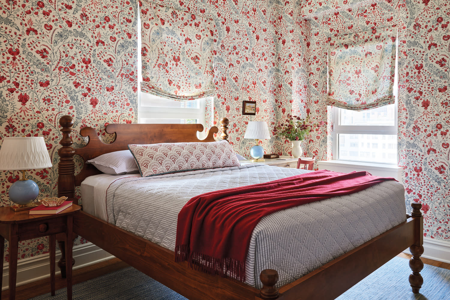 bedroom with vintage red floral wallpaper and matching curtains