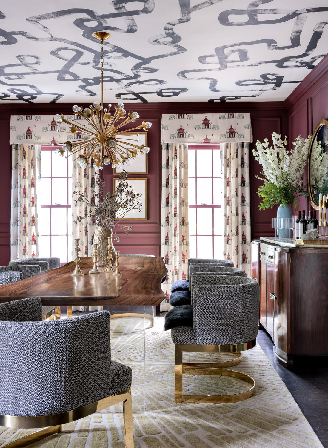 purple dining room with a patterned ceiling and blue and gold chairs
