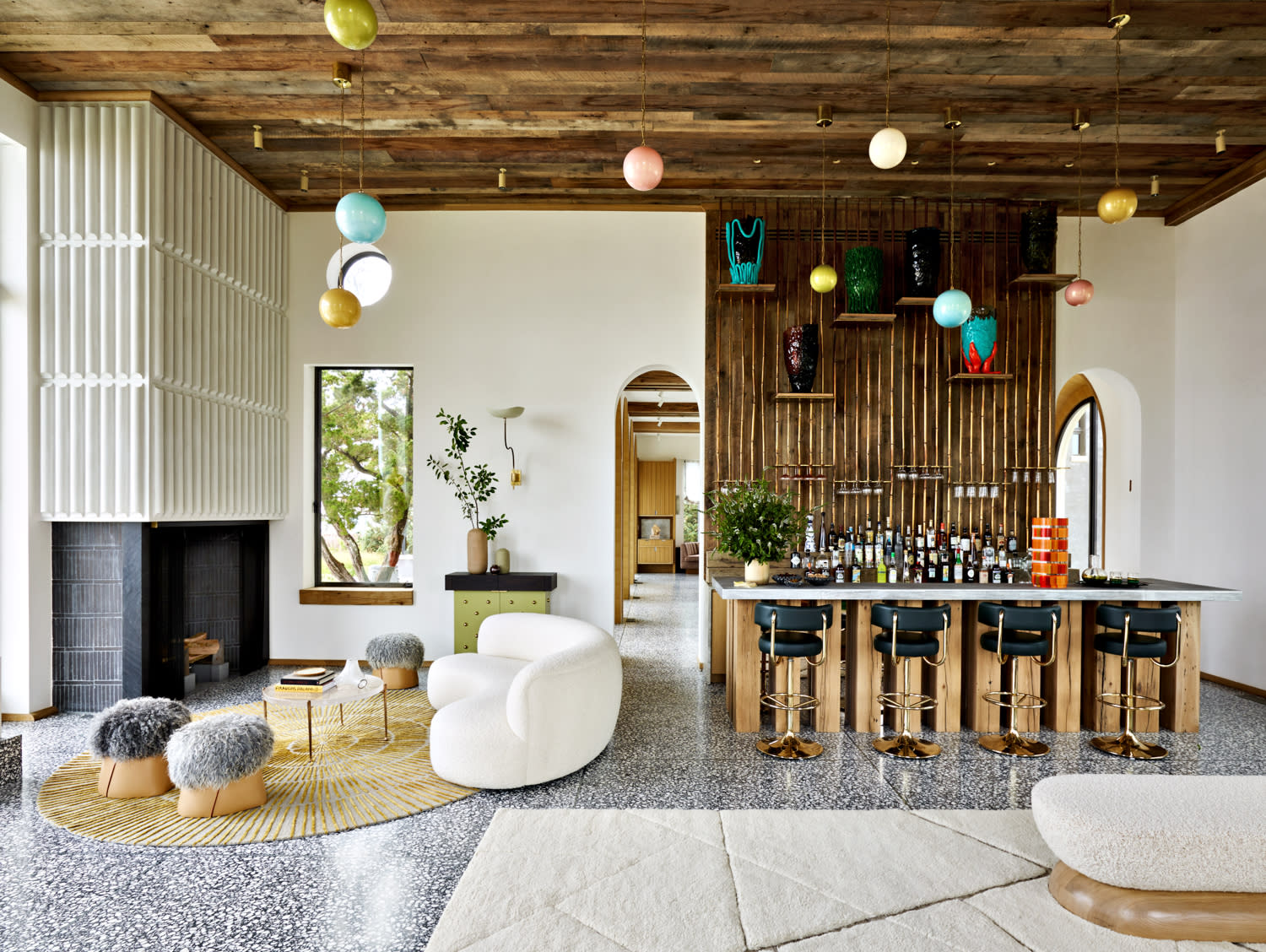 colorful spherical lighting fixtures hang above this contemporary living room