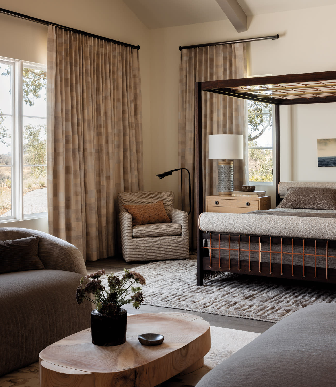 mehraban rug, bed, seating area and coffee table in bedroom by Caitlin Jones Ghajar