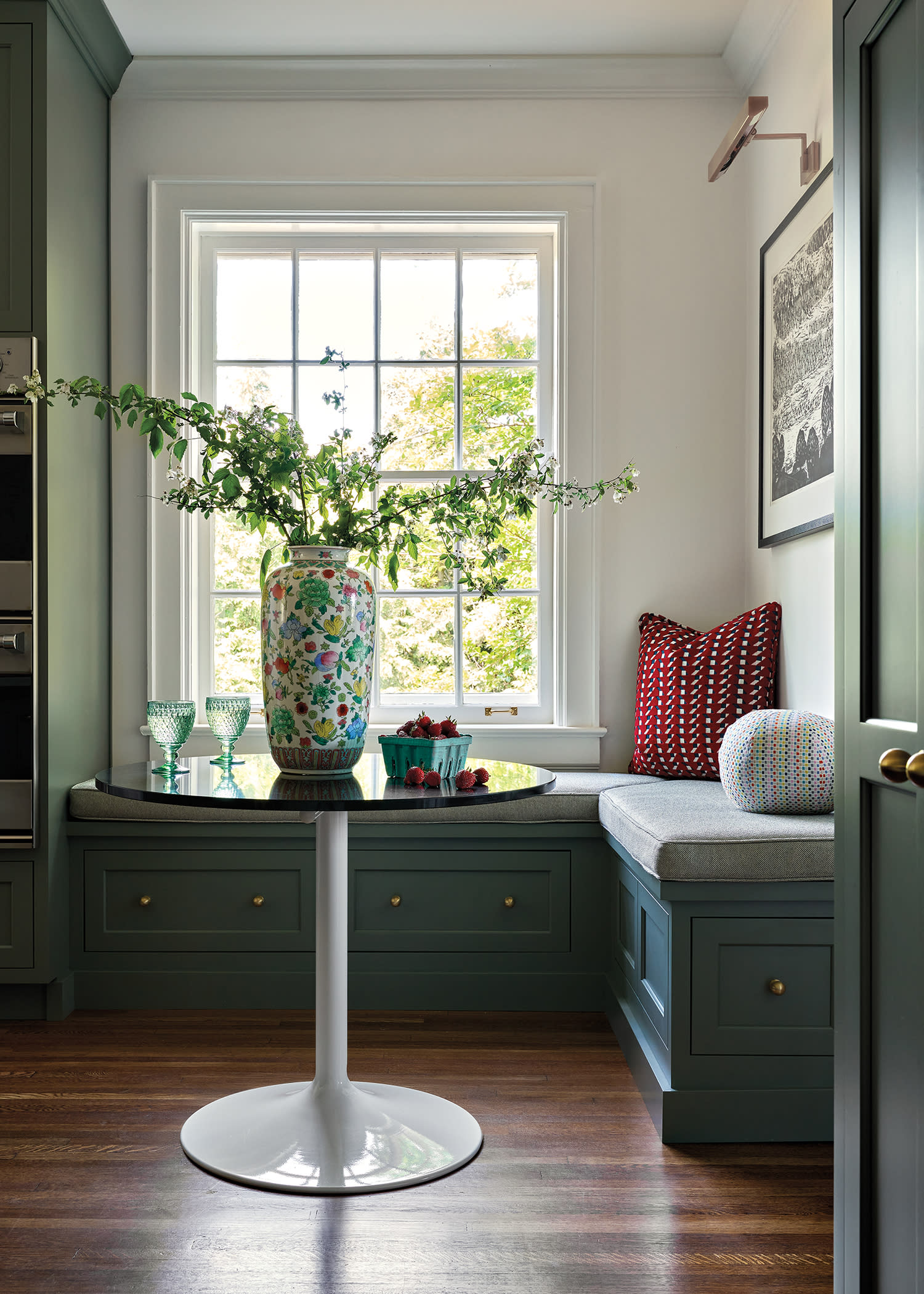 breakfast nook with a green banquette seat topped with a grey cushion